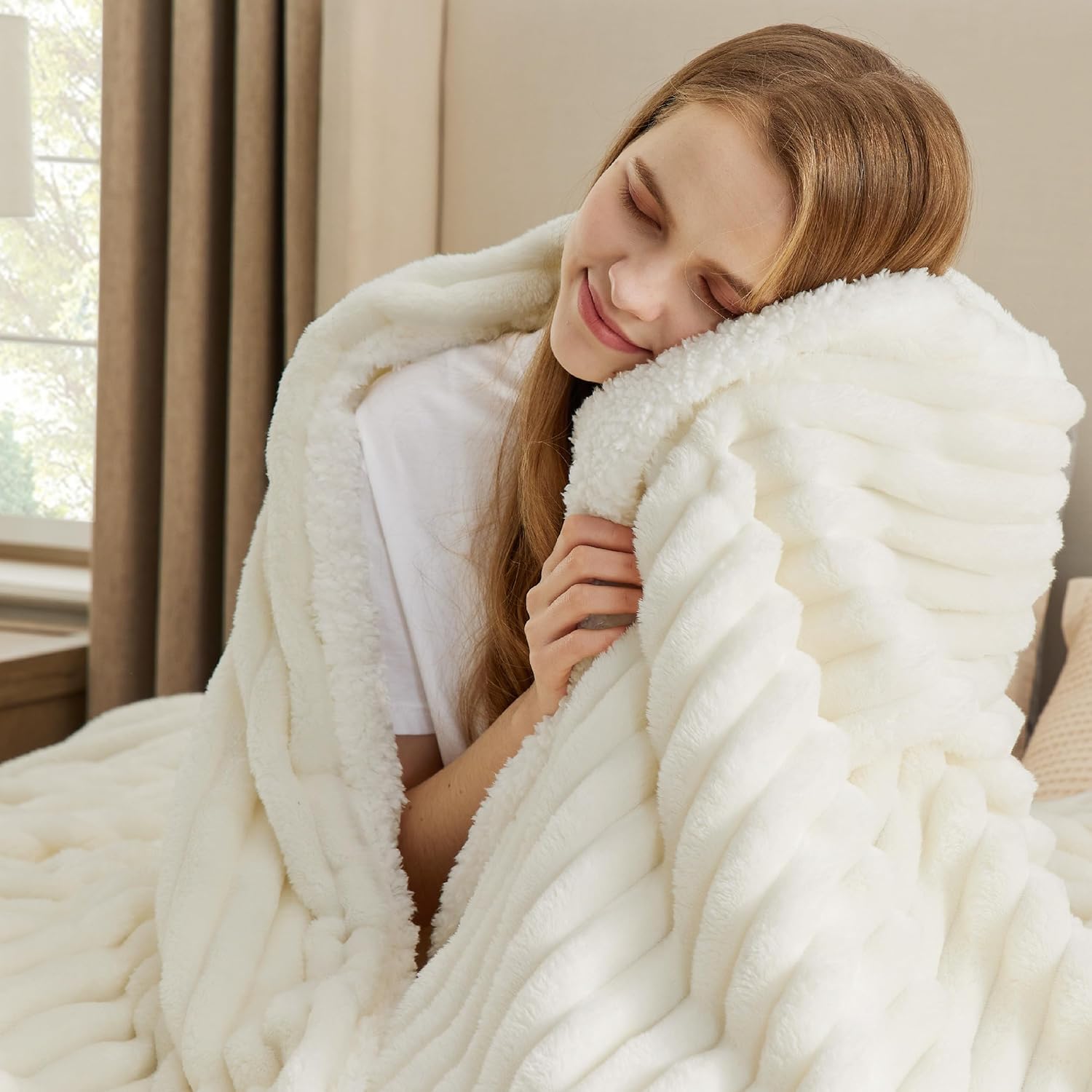 White plush fleece throw on bed
